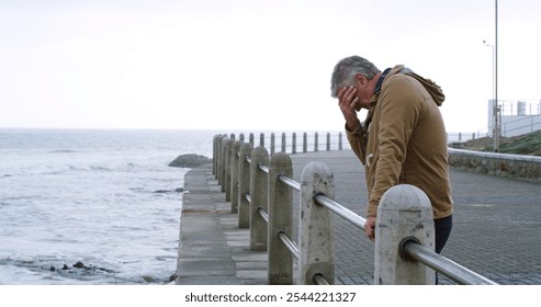 Senior man, thinking and sad by sea promenade with headache, stress and reflection. Person, depression and insight for mistake, crying and decision with anxiety by ocean, waves and outdoor in Italy - Powered by Shutterstock