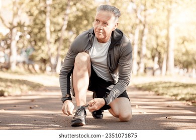 Senior man, tie shoelace and running, fitness and cardio in the park, start and health, wellness and vitality. Runner is ready for exercise, athlete and sports with sneakers, path outdoor and active - Powered by Shutterstock