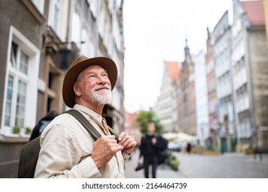 Senior man tourist outdoors sightseeing in historic town. - Powered by Shutterstock