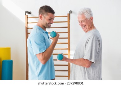 Senior man training with his coach in fitness studio - Powered by Shutterstock