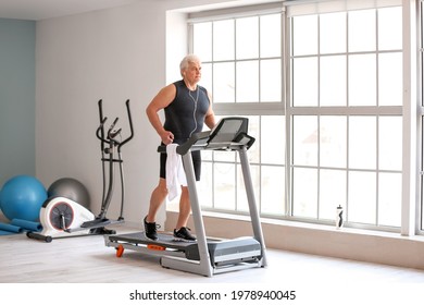 Senior Man Training On Treadmill In Gym