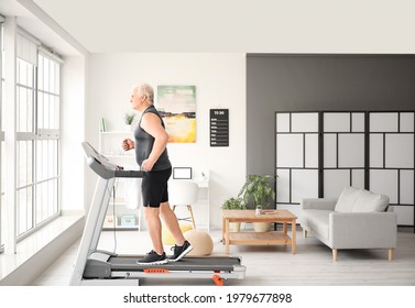 Senior Man Training On Treadmill At Home