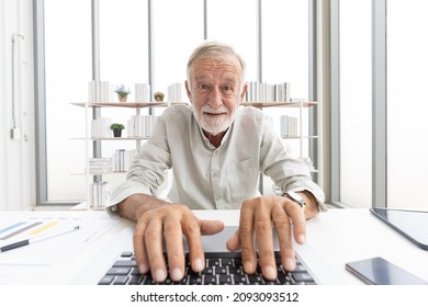 Senior Man Typing Keyboard On Laptop Computer, Talking And Looking To Someone From Chat Online