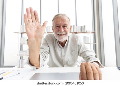 Senior Man Typing Keyboard On Laptop Computer And Say Hello Or Goodbye With Someone From Chat Online