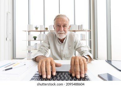 Senior Man Typing Keyboard On Laptop Computer, Talking And Looking To Someone From Chat Online