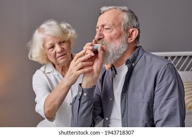 Senior Man Using Asthma Inhaler For Relief An Attack At Home For Preventing Attack, Wife Support