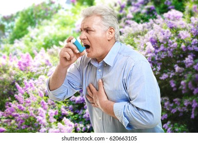 Senior Man Using Asthma Inhaler Outdoor