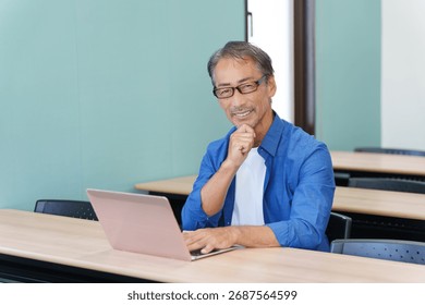 A senior man using a computer and thinking carefully