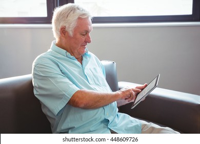 Senior man using a digital tablet in a retirement home