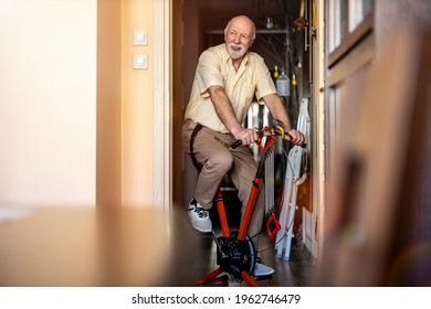 Senior Man Using Exercise Bike At Home
