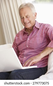 Senior Man Using Laptop At Home