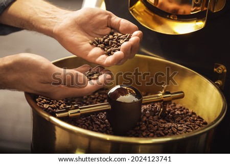 Senior man using modern coffee roaster, closeup