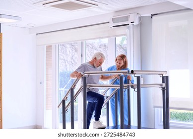 Senior man using parallel bars with physiotherapist assistance for mobility training in rehab center. This image can be used for commercial purposes related to healthcare rehabilitation and senior care.