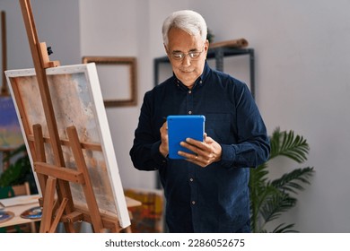 Senior man using touchpad drawing at art studio - Powered by Shutterstock