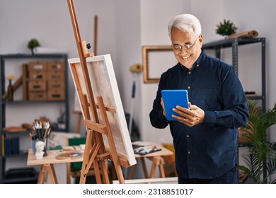 Senior man using touchpad drawing at art studio - Powered by Shutterstock