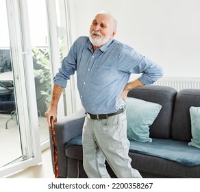 Senior Man Using A Walking Cane Having A Backpain At Home