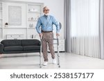 Senior man using walking frame at home