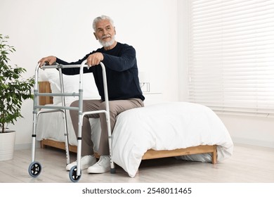 Senior man with walking frame on bed in hospital ward. Space for text - Powered by Shutterstock