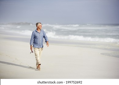 Senior Man Walking On Beach
