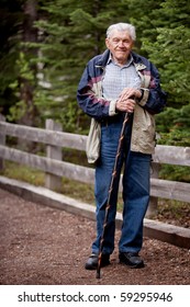 A Senior Man Walking Outdoors On A Path