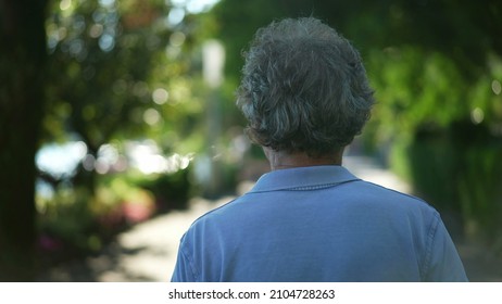 Senior Man Walking Outside In Nature. Back Of Older Person In A Path Walk