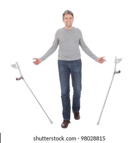 Senior Man Walking Using Crutches. Isolated On White