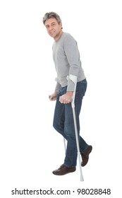 Senior Man Walking Using Crutches. Isolated On White