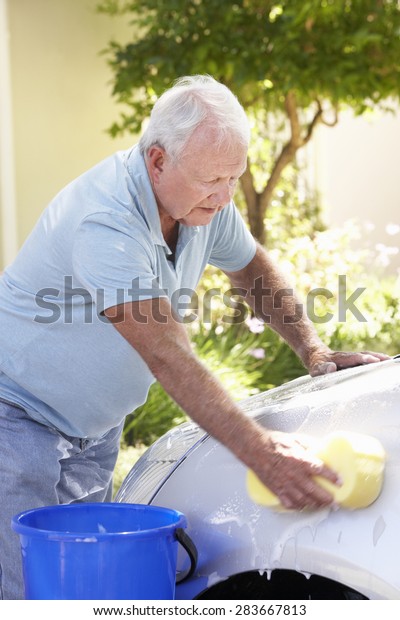 Senior Man Washing Car In\
Drive