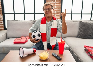 Senior Man Watching Football Holding Ball Supporting Team Smiling Happy Pointing With Hand And Finger To The Side 