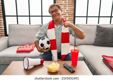 Senior Man Watching Football Holding Ball Supporting Team Pointing Finger To One Self Smiling Happy And Proud 