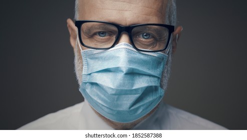 Senior man wearing a face mask and glasses, coronavirus prevention concept - Powered by Shutterstock