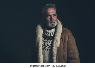 Senior Man Wearing Knitted Sweater And Lambs Wool Coat.