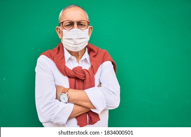 Senior Man Wearing Medical Mask And Glasses Standing At The City.