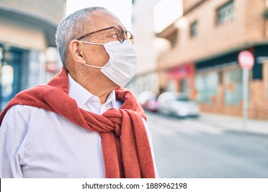 Senior man wearing medical mask and glasses standing at the city. - Powered by Shutterstock