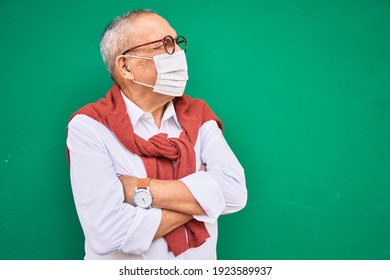 Senior Man Wearing Medical Mask And Glasses Standing At The City.