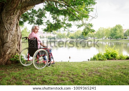 Similar – Older woman in a wheelchair