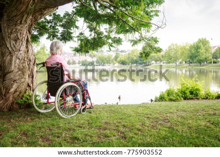 Similar – Older woman in a wheelchair