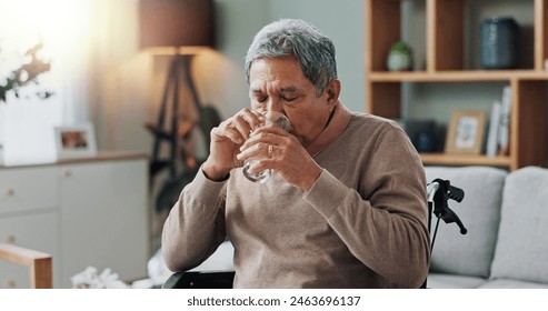 Senior man, wheelchair and drinking water in home with depression, sick or stress in retirement. Glass, house and elderly person with a disability, disease or frustrated with parkinson in living room - Powered by Shutterstock