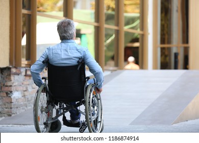 Senior Man In Wheelchair Near Ramp Outdoors