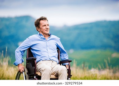 Senior Man In Wheelchair Outside In Nature