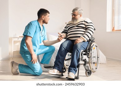 Senior man in wheelchair with pulse oximeter and caregiver at home - Powered by Shutterstock