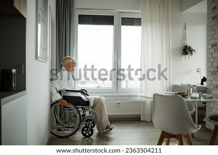 Similar – Senior woman in wheelchair alone in room