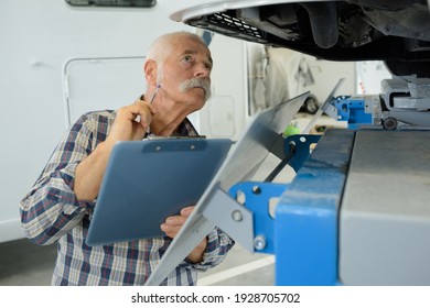 Senior Man While Repairing Caravan