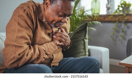 Senior man who suffers, shrinks and has difficulty breathing, chest pain or heart attack during the corona virus pandemic crisis, life insurance. Heart attack symptoms. Senior health care concepts