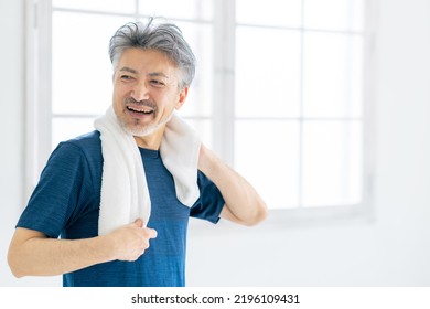 A Senior Man Wiping His Sweat With A Towel. Active Senior.