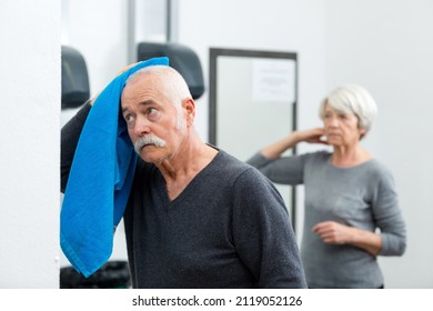 Senior Man Wiping Sweat Of His Forehead