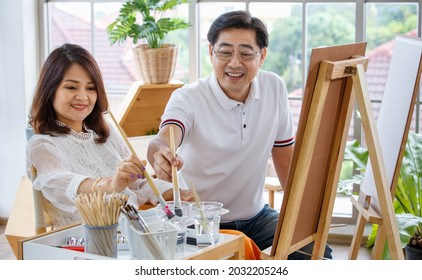 Senior Man And Woman Couple, Husband And Wife, Painting Image Together In Home Gallery With Warm And Happy Circumstance. Idea For Time-sharing And Relaxing For Older People After Retirement.