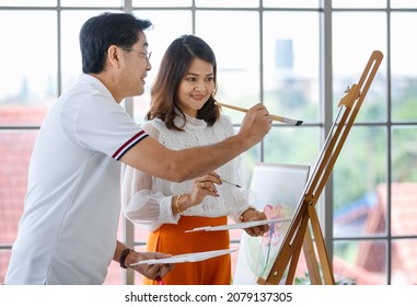 Senior Man And Woman Couple, Husband And Wife, Painting Image Together In Home Gallery With Warm And Happy Circumstance. Idea For Time-sharing And Relaxing For Older People After Retirement.