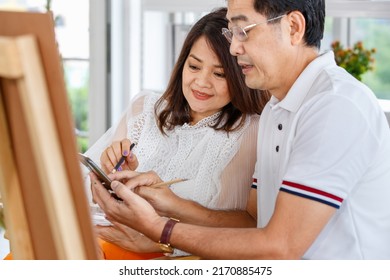 Senior Man And Woman Couple, Husband And Wife, Painting Image Together In Home Gallery With Warm And Happy Circumstance. Idea For Time-sharing And Relaxing For Older People After Retirement.