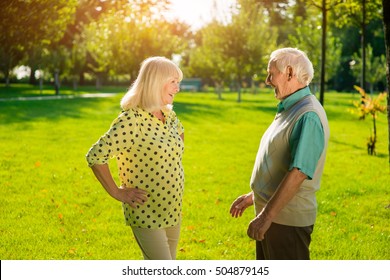 Senior Man And Woman Outdoors. People Smiling To Each Other. Nice To See You Again. So Many Memories.